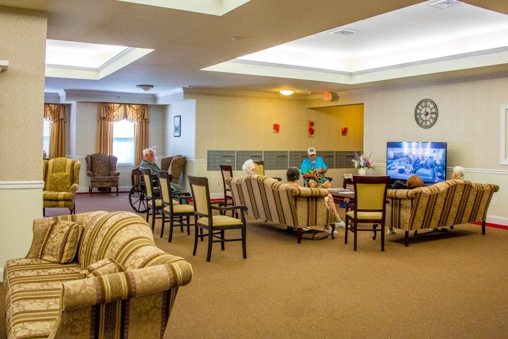 Main community room with residents watching TV
