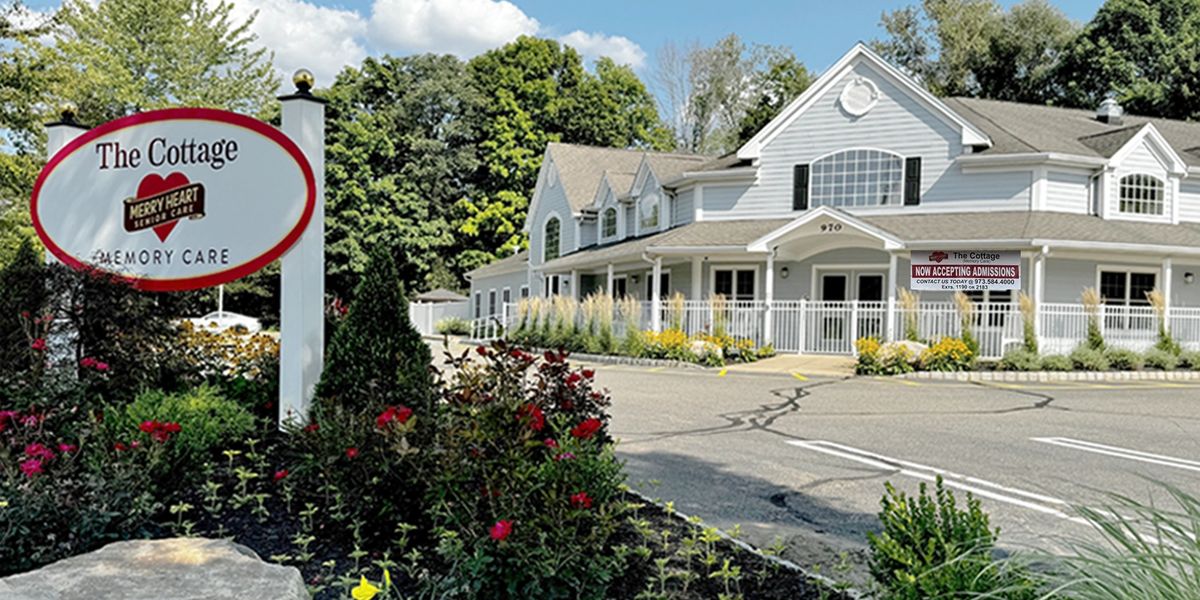 The Cottage Memory Care senior living facility with a welcoming garden and parking area.