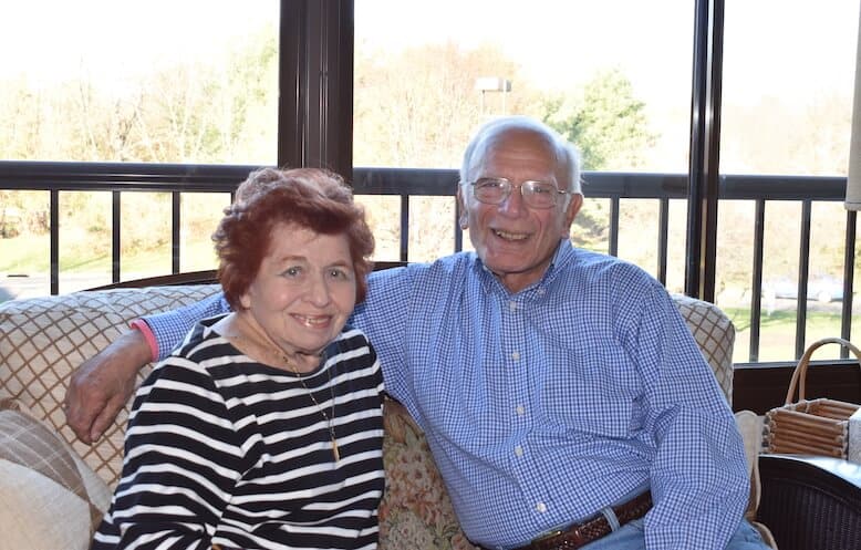 senior couple smiling on couch