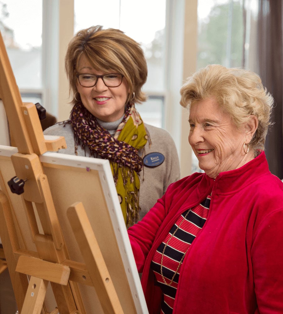 Resident and staff member painting